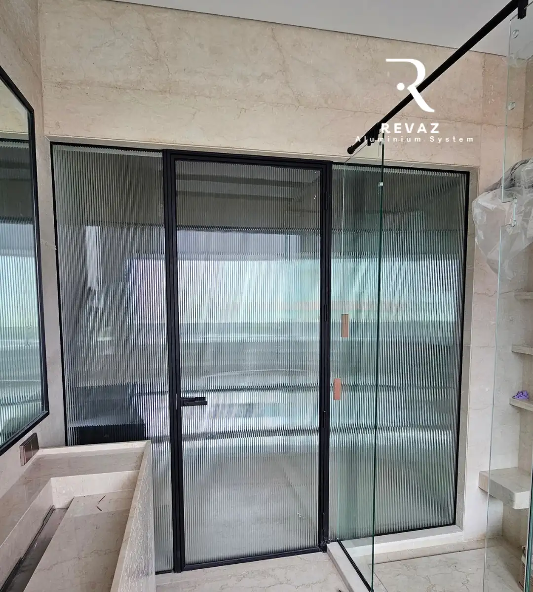 Revaz ribbed-glass aluminium door installation